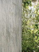 Close-up of Haze Indigo wide-width sheer fabric, showing light ecru base with delicate blue stitched details and soft drape texture by Christopher Farr Cloth.